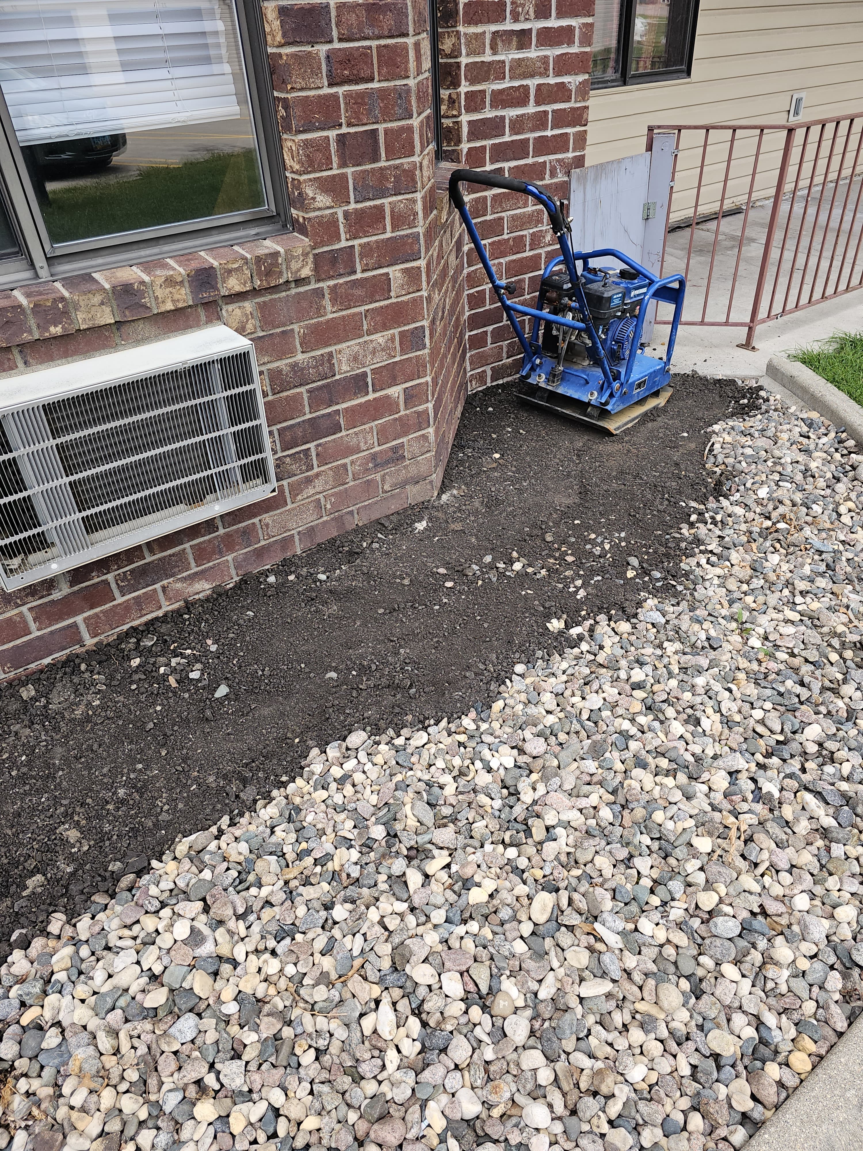 Professional gravel landscaping with compactor in Fargo ND