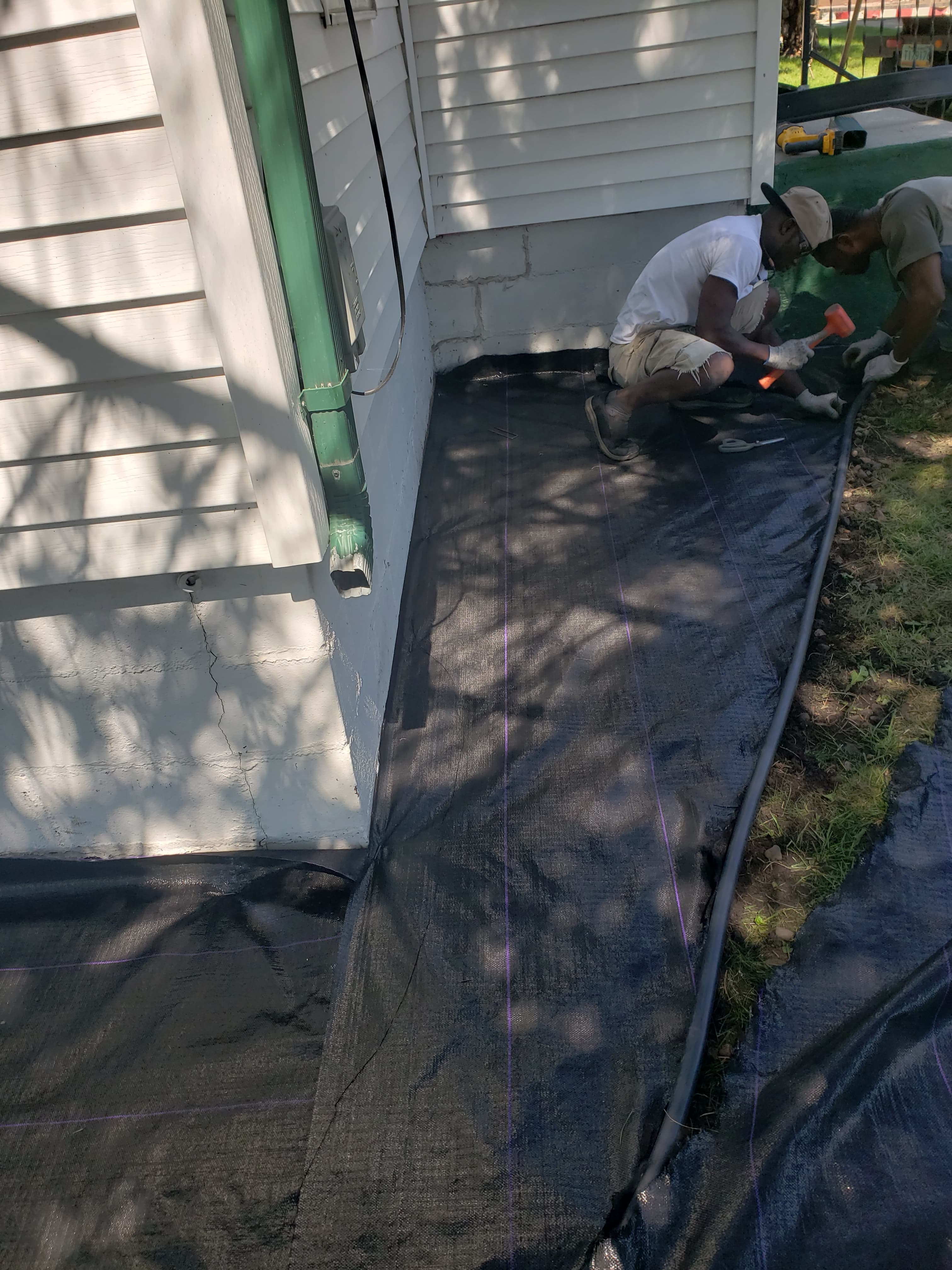 Landscaping crew installing barrier in Fargo ND