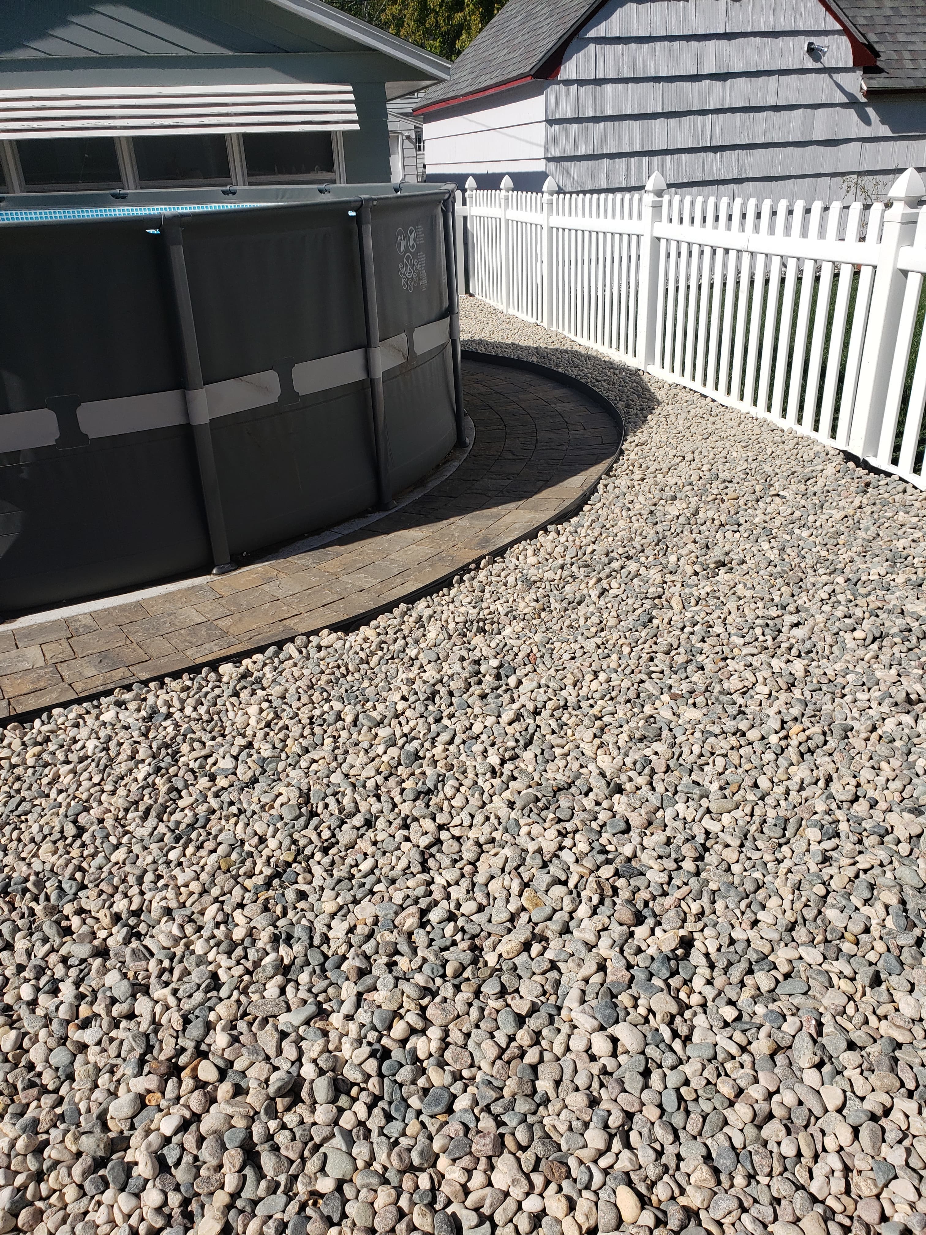 Finished gravel and paver pool area landscaping in Fargo ND