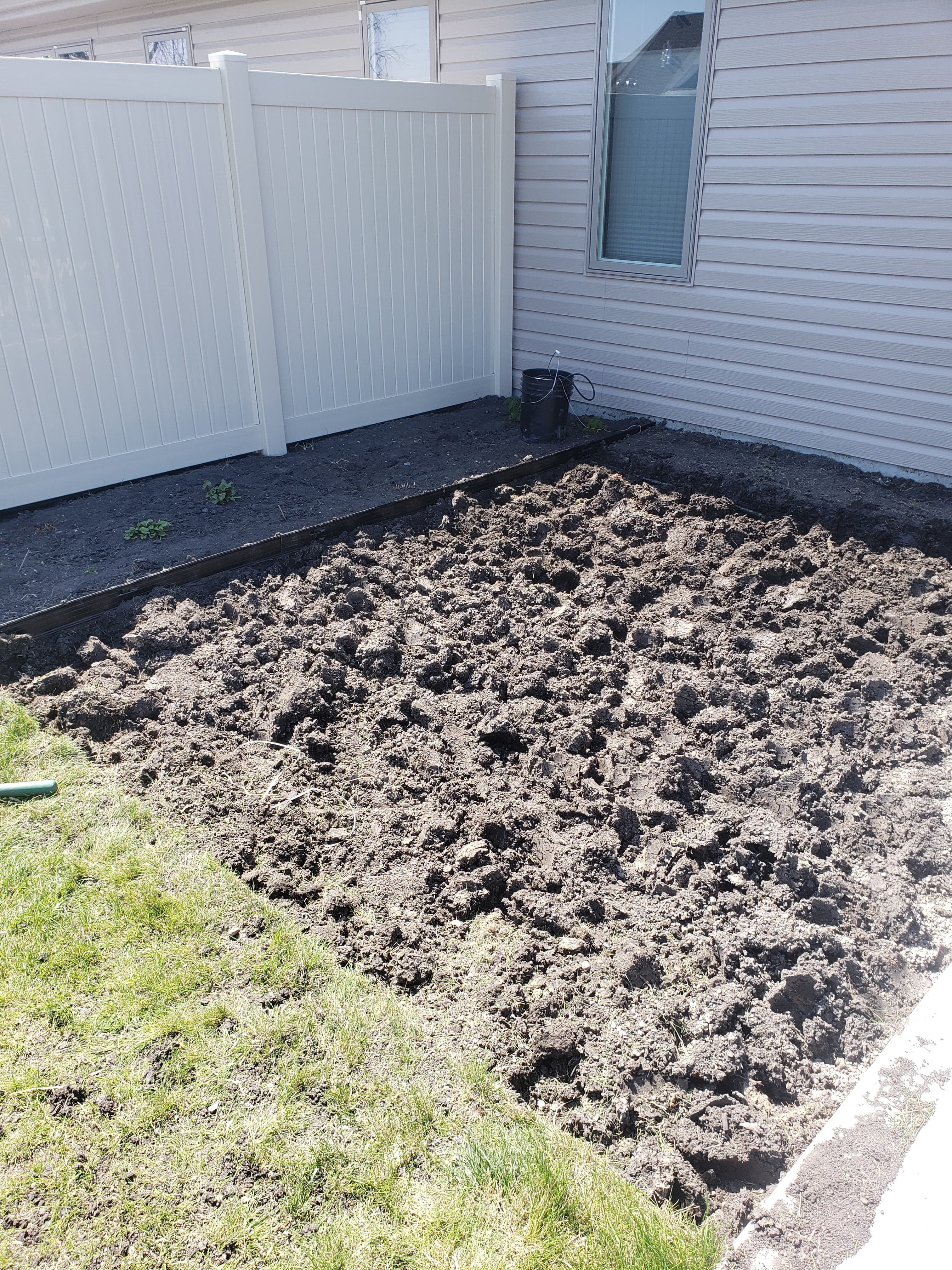 Bare dirt yard before paver installation in West Fargo